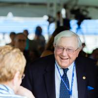 Don Lubbers, Jim and Donna Brooks, and Chick Blue talking at the Jamie Hosford Football Center dedication.